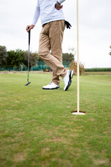 Fototapeta premium Shot of an unrecognizable golfer standing on the golf course.