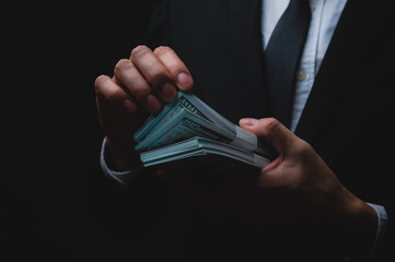Closeup of hands of a young male businessman and entrepreneur wearing formal clothing in suit and...