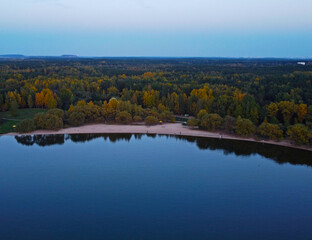 Evening lake shore with forest