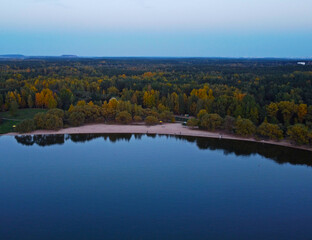 Evening lake shore with forest