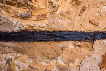 Background on a wall made of stone and clay with wood structure