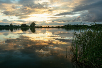 Evening clouds over the lake with reeds
