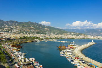 Landscape view of the Alanya bay in Turkey with pirate ships, lighthouse and Red Tower