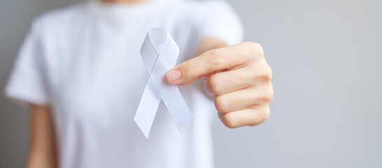 Woman holding white Ribbon for November Lung Cancer Awareness month, democracy and international peace day. Healthcare concept