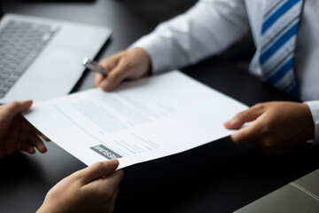 Manager receives resume from applicants who are interviewing for an accounting position at a company, HR managers reviewing applicants' resumes, job interview ideas and recruiting.