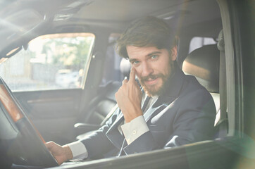 Fototapeta na wymiar businessmen in a suit in a car a trip to work self confidence