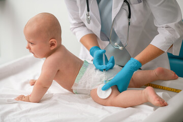 Tranquil cute neonate receiving an intramuscular injection