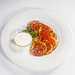 Delicious pancakes with red caviar. Russian and Ukrainian cuisine. The concept of the Maslenitsa holiday.