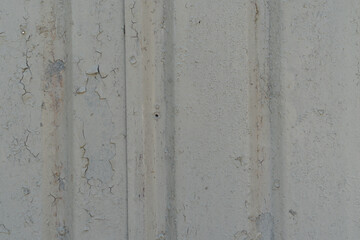 Garage corrosion on a rough striped metal wall or floor, scratches, air holes, rusty house fence, holes, dents, pins.