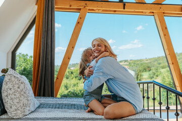 Daughter and mother embracing at home