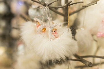 Close up of Christmas location with white angels toys on the branch