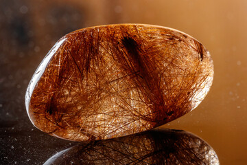 Macro mineral stone Rutile in quartz on background