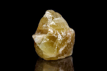 Macro mineral stone yellow Calcite on a black background