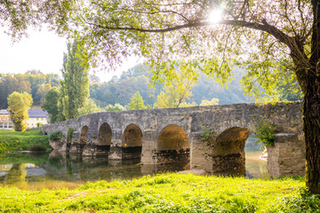 Fototapeta na wymiar Old stone bridge on the river Dobra in Karlovac county, Croatia 