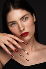 Portrait of a beautiful woman with classic make up in glamorous style, creative long nails. Design...