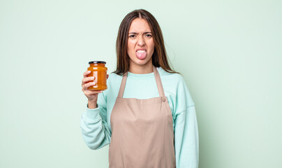 young pretty woman feeling disgusted and irritated and tongue out. peach jelly concept - obrazy, fototapety, plakaty