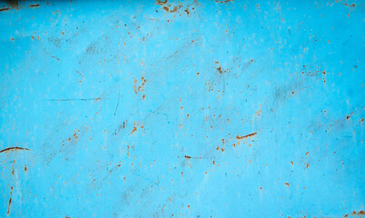 Metal sheet painted in light blue with flashes of rust,background,texture,copy space