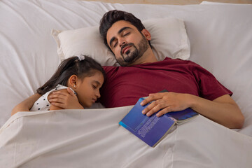 A FATHER AND DAUGHTER SLEEPING TOGETHER