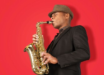 Beautiful golden saxophone on red background,