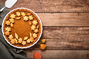 Pumpkin Pie. Tart with whipped cream and cinnamon on rustic background. Traditional american homemade pumpkin cake for Thanksgiving or Halloween Ready to eat. Mock up.