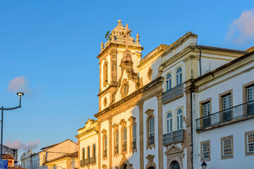 Fototapeta na wymiar Facade of an old and historic church from the 18th century in the central square of the Pelourinho district in the city of Salvador, Bahia lighting by the sunset