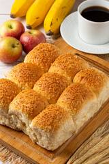 Breakfast table with coconut bread and fruits.