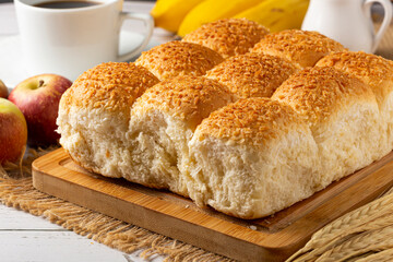 Breakfast table with coconut bread and fruits.