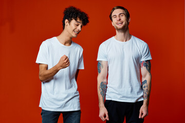 funny two friends in white t-shirts posing Studio