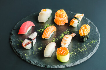 Maki and nigiri sushi variety with salmon, shrimp, avocado and tuna at a sushi restaurant
