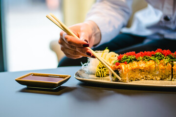 Maki and nigiri sushi variety with salmon, shrimp, avocado and tuna at a sushi restaurant
