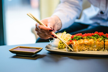 Maki and nigiri sushi variety with salmon, shrimp, avocado and tuna at a sushi restaurant