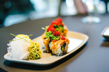 Maki and nigiri sushi variety with salmon, shrimp, avocado and tuna at a sushi restaurant