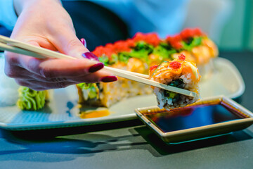 Maki and nigiri sushi variety with salmon, shrimp, avocado and tuna at a sushi restaurant