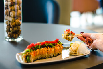 Maki and nigiri sushi variety with salmon, shrimp, avocado and tuna at a sushi restaurant