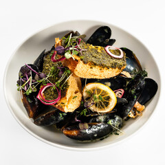 Mussel with bread restaurant plate. Restaurant appetizer plate on white table. Summer or spring restaurant food concept