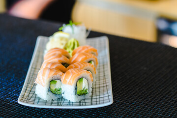 Maki and nigiri sushi variety with salmon, shrimp, avocado and tuna at a sushi restaurant