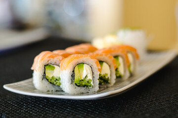Maki and nigiri sushi variety with salmon, shrimp, avocado and tuna at a sushi restaurant
