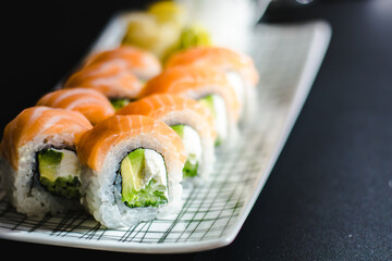 Maki and nigiri sushi variety with salmon, shrimp, avocado and tuna at a sushi restaurant