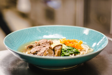 Beef ramen soup with poached egg and vegetables at a restaurant