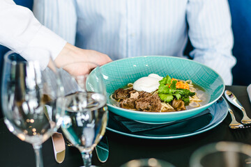 Beef ramen soup with poached egg and vegetables at a restaurant