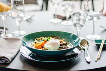 Beef ramen soup with poached egg and vegetables at a restaurant