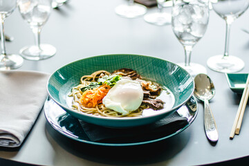 Beef ramen soup with poached egg and vegetables at a restaurant