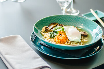 Beef ramen soup with poached egg and vegetables at a restaurant
