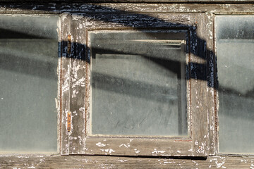 Fragment Old wooden window with dusty glass.