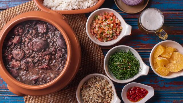 Typical Brazilian dish called Feijoada. Slide shot with smoke. Top View