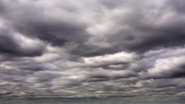 Heavy clouds roiling over the open sky in time-lapse sequence