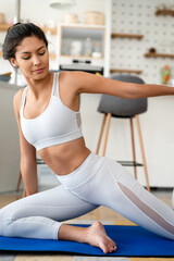 Fototapeta premium Sporty beautiful woman exercising at home to stay fit