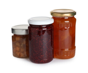 Jars with different jams on white background