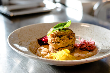 Pike cutlet with pumpkin sauce and fermented cabbage in different colors at a restaurant
