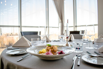 Pike cutlet with pumpkin sauce and fermented cabbage in different colors at a restaurant